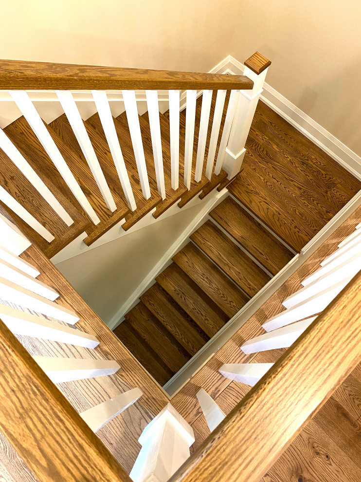 Mid-sized contemporary wood u-shaped staircase in Toronto with wood risers and wood railing.