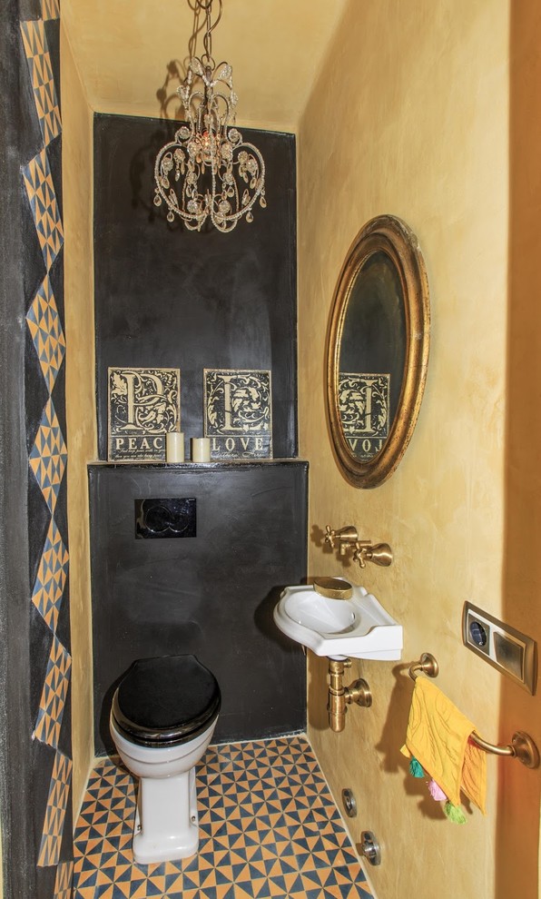 Design ideas for a small eclectic powder room in Other with a one-piece toilet and a wall-mount sink.