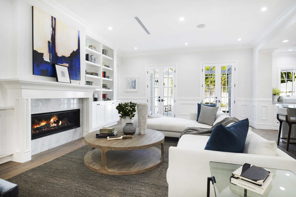 Photo of a transitional open concept living room in Los Angeles with white walls, dark hardwood floors, a ribbon fireplace, a stone fireplace surround and brown floor.