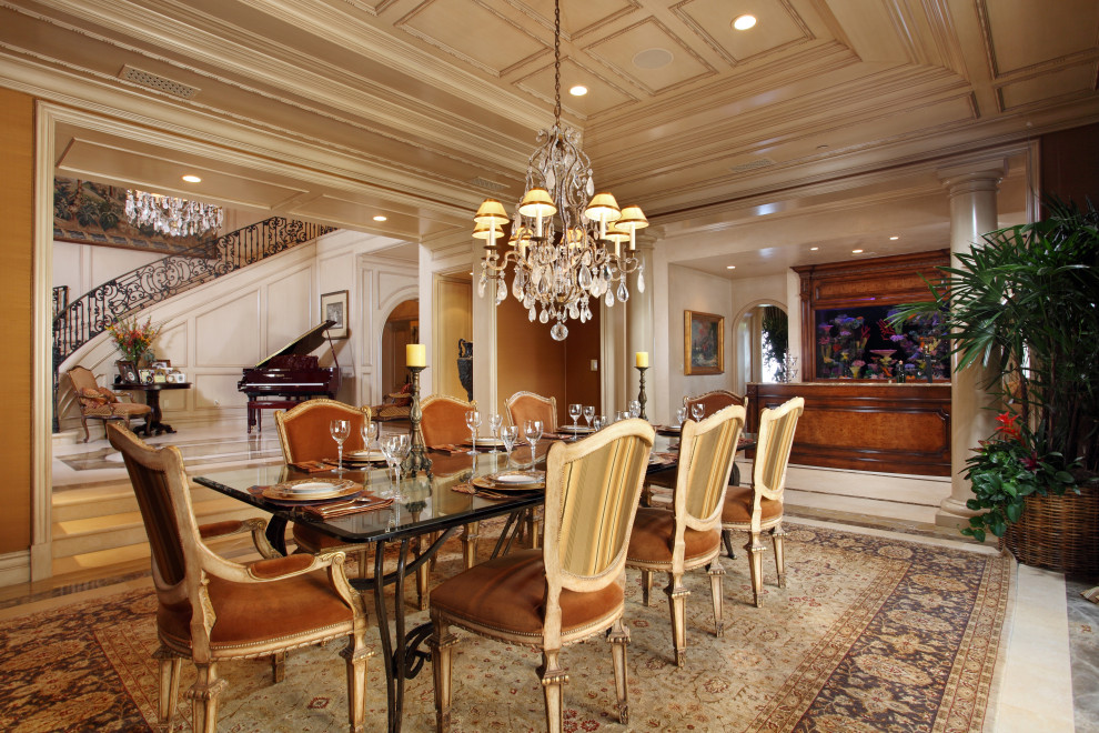 Large mediterranean separate dining room in Orange County with white walls, marble floors and beige floor.