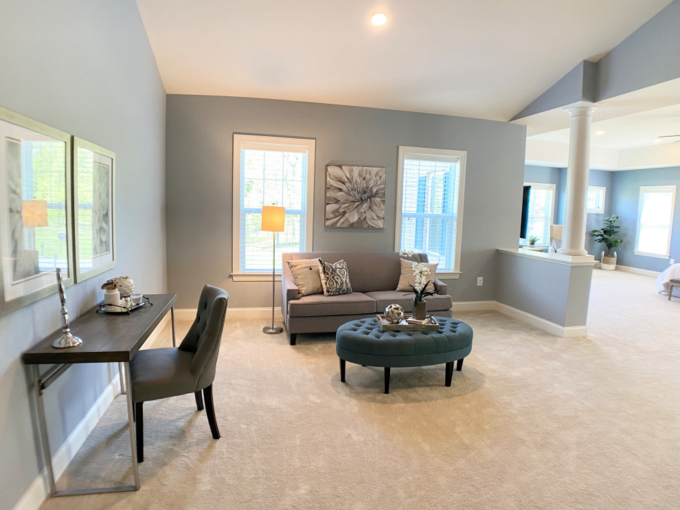 This is an example of an expansive transitional master bedroom in DC Metro with blue walls, carpet, no fireplace and white floor.