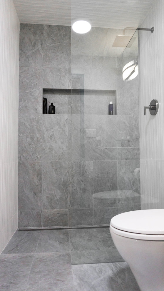 Inspiration for a small contemporary bathroom in Phoenix with a walk-in shower, a two-piece toilet, grey tiles, travertine tiles, grey walls, travertine flooring, a wall-mounted sink and grey floors.
