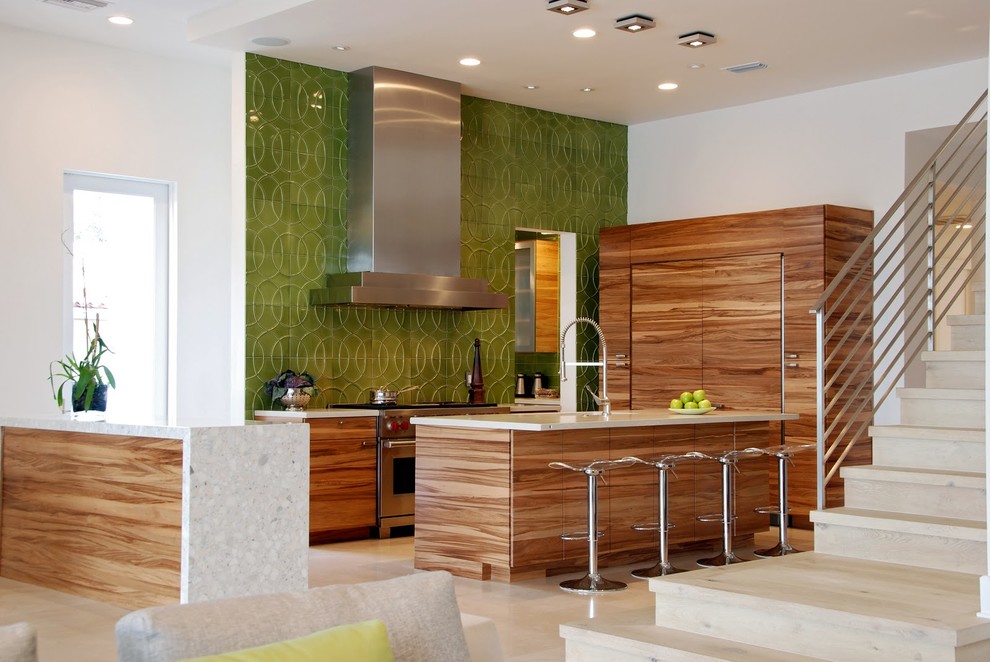 Design ideas for a contemporary u-shaped open plan kitchen in Tampa with flat-panel cabinets, medium wood cabinets, green splashback and panelled appliances.