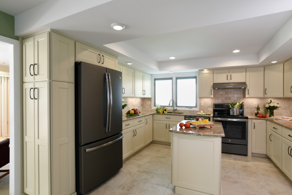 Enclosed kitchen - mid-sized transitional u-shaped porcelain tile, beige floor and tray ceiling enclosed kitchen idea with an undermount sink, flat-panel cabinets, beige cabinets, quartz countertops, beige backsplash, travertine backsplash, black appliances, an island and beige countertops