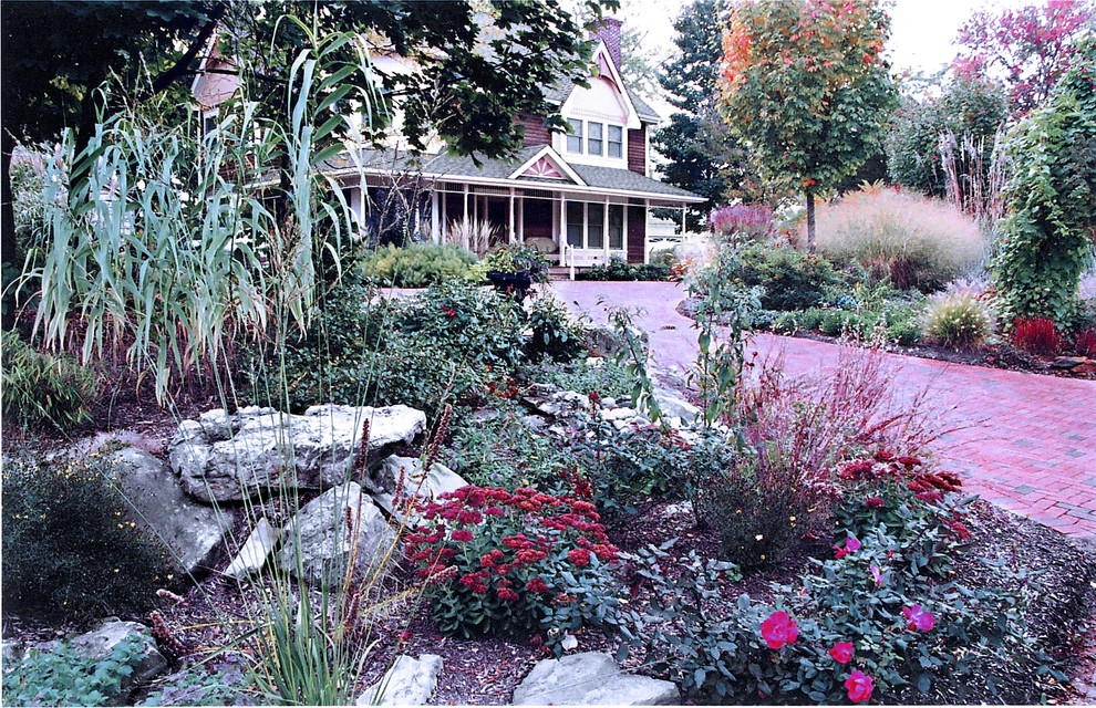 Inspiration for a large country front yard driveway for fall in New York with brick pavers.