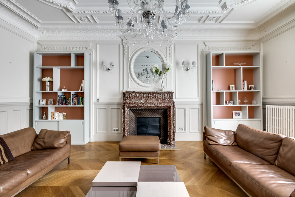 Inspiration for a large traditional enclosed living room in Paris with a library, white walls, medium hardwood floors, a standard fireplace, a stone fireplace surround and no tv.