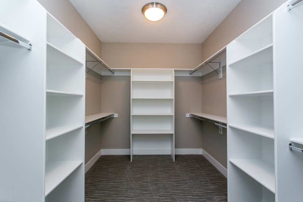 Photo of a large transitional gender-neutral walk-in wardrobe in Seattle with open cabinets, white cabinets, carpet and grey floor.