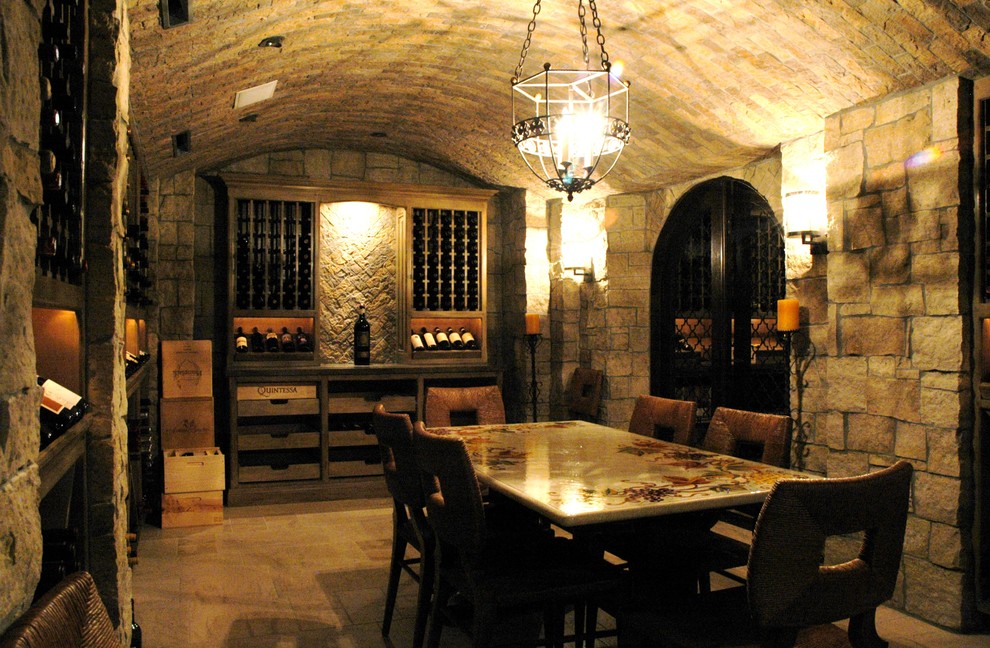 Photo of a large traditional wine cellar with storage racks and ceramic floors.