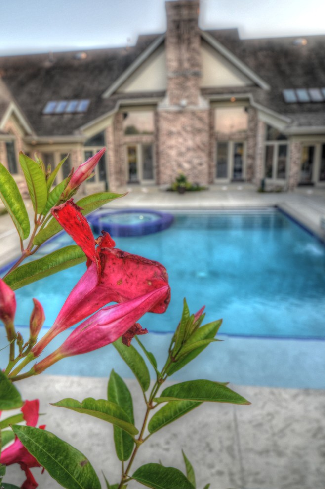 Inspiration for a large transitional backyard concrete paver and rectangular natural hot tub remodel in Cedar Rapids
