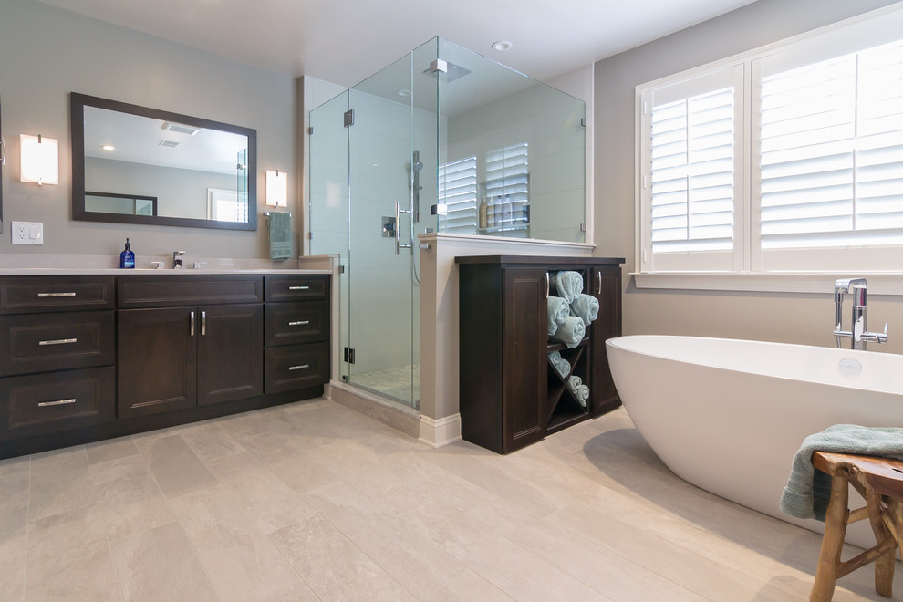 Design ideas for a large contemporary master bathroom in Philadelphia with raised-panel cabinets, dark wood cabinets, a freestanding tub, a corner shower, grey walls, an undermount sink, wood benchtops, beige floor, a hinged shower door and beige benchtops.