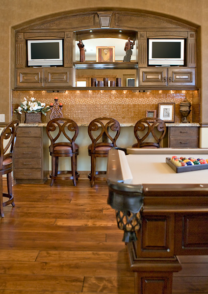 Expansive mediterranean home bar in Orange County with medium hardwood floors.