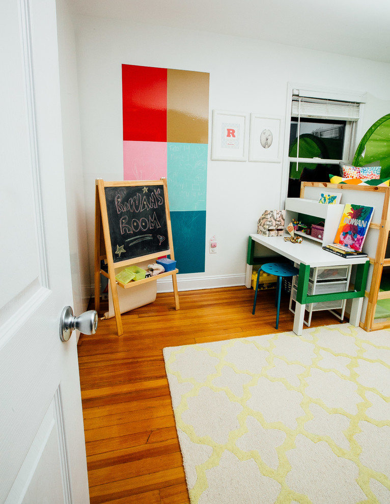This is an example of a small contemporary kids' bedroom for kids 4-10 years old and girls in New York with grey walls, dark hardwood floors and brown floor.