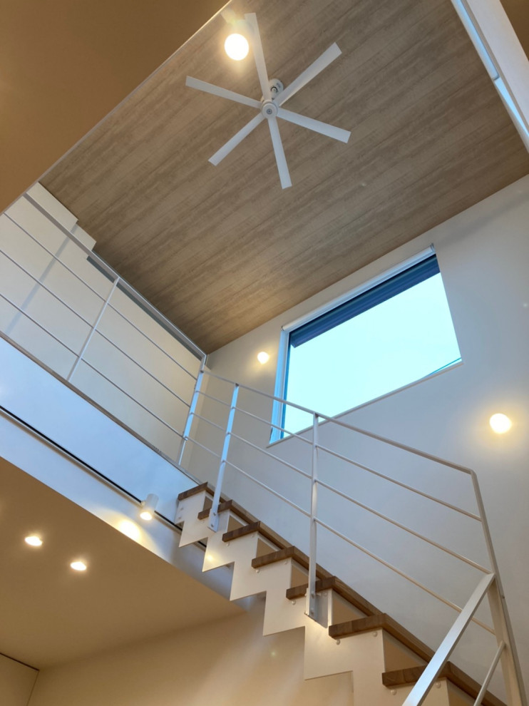Стильный дизайн: угловая деревянная лестница в стиле модернизм с деревянными ступенями, металлическими перилами и обоями на стенах - последний тренд