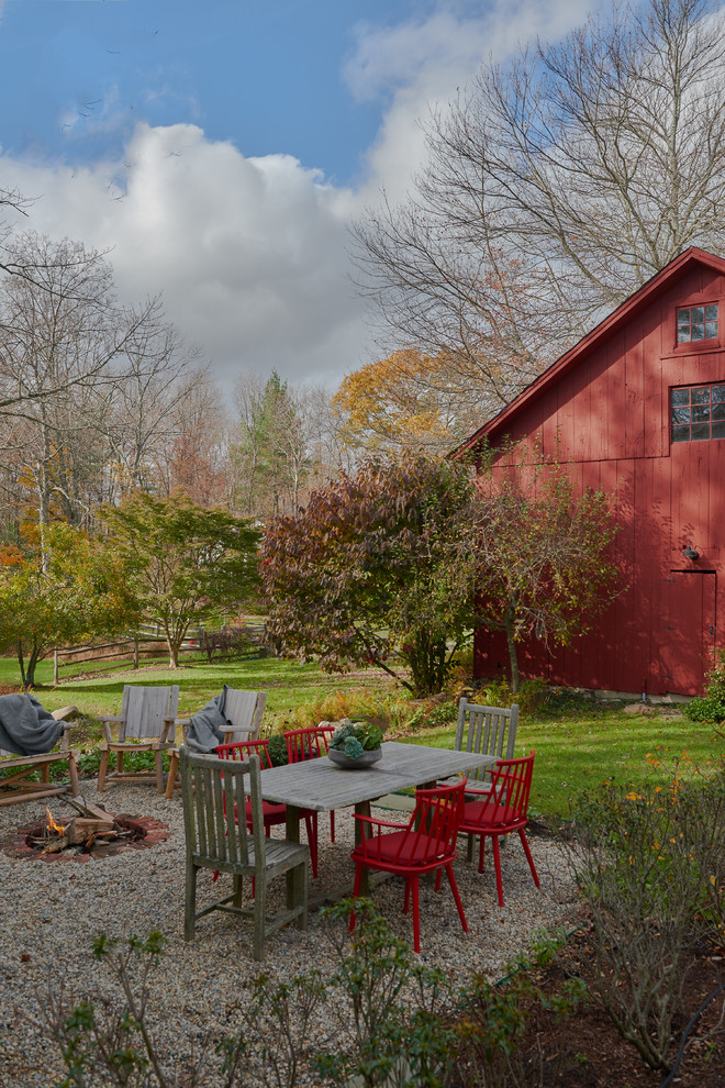 Inspiration for a mid-sized country side yard gravel patio remodel in New York with a fire pit