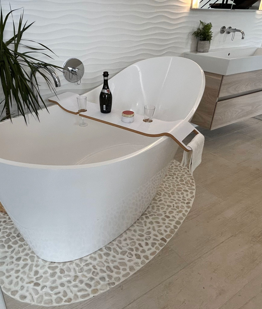 Design ideas for a large scandinavian master wet room bathroom in Berkshire with flat-panel cabinets, light wood cabinets, a freestanding tub, a wall-mount toilet, white tile, porcelain tile, white walls, porcelain floors, a trough sink, white floor, an open shower, an enclosed toilet, a single vanity, a floating vanity and coffered.
