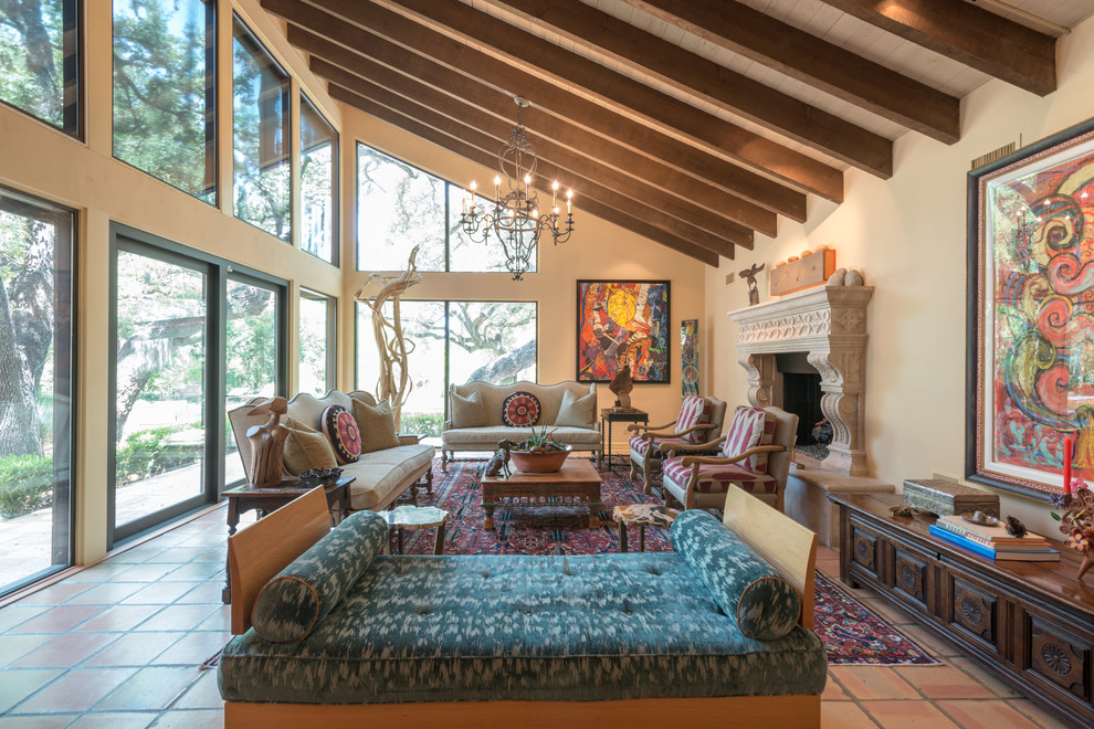 Inspiration for an expansive eclectic formal open concept living room in Other with a stone fireplace surround, terra-cotta floors, a standard fireplace, orange floor and beige walls.