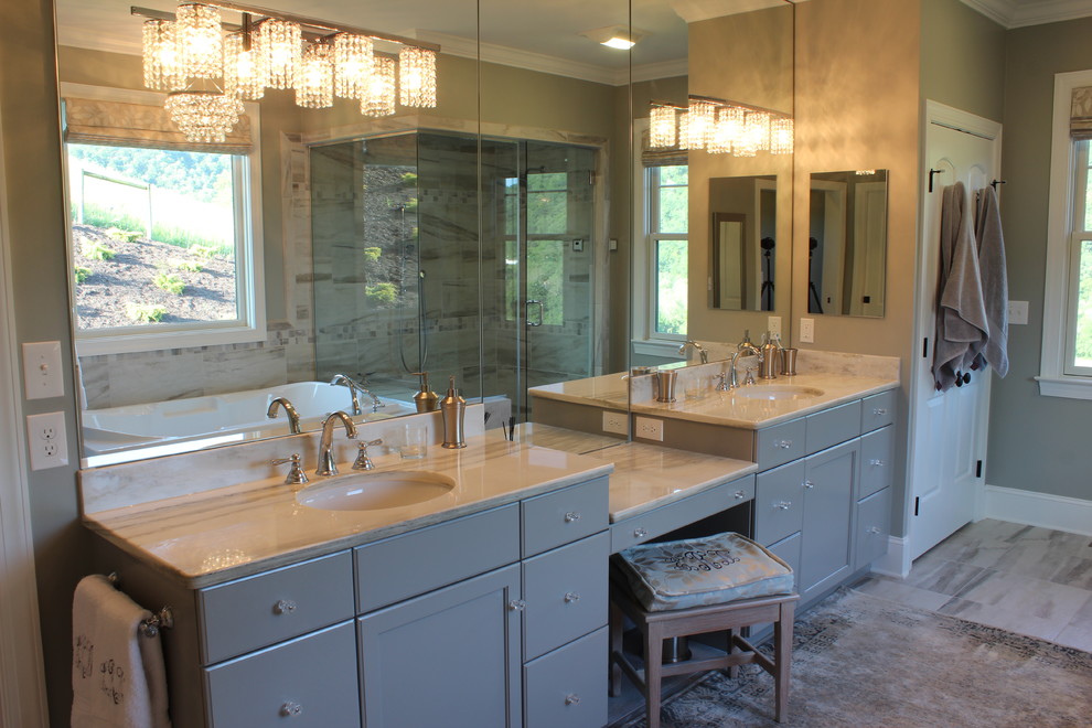 Large transitional master bathroom in Other with an undermount sink, flat-panel cabinets, grey cabinets, granite benchtops, a drop-in tub, a corner shower, gray tile, ceramic tile, grey walls, ceramic floors and a two-piece toilet.