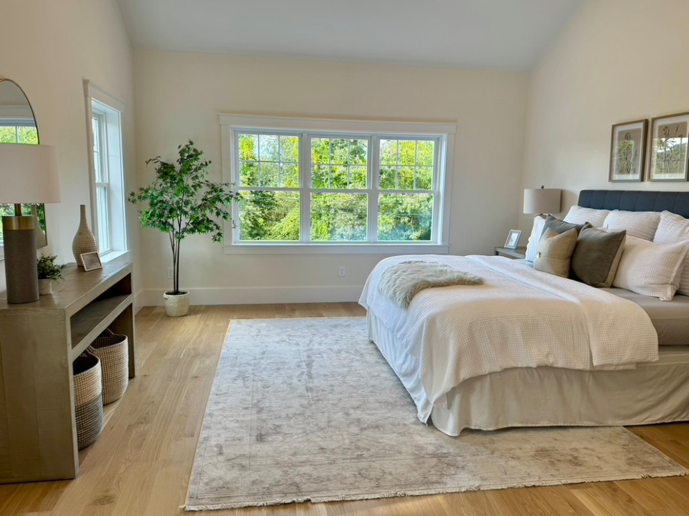 Example of a transitional master medium tone wood floor and brown floor bedroom design in Boston with beige walls