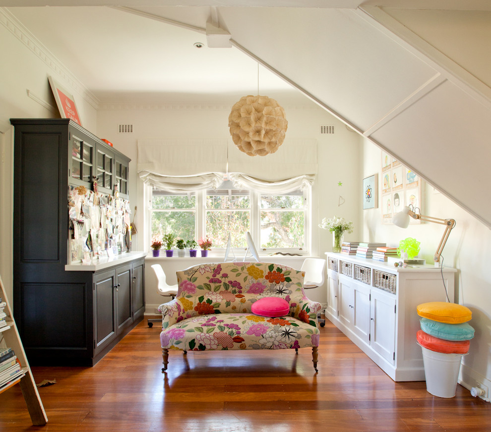 This is an example of an eclectic home office in Perth with white walls, dark hardwood floors and a freestanding desk.
