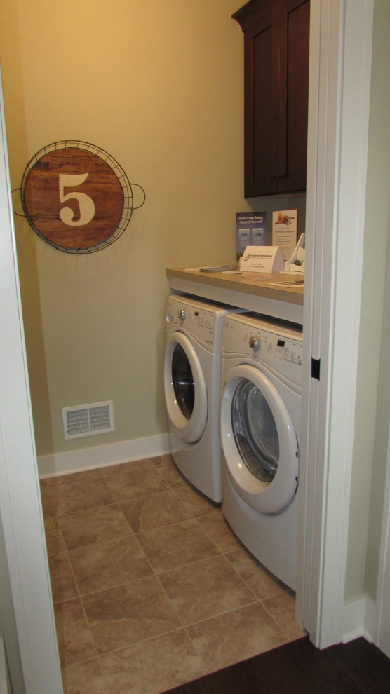 Home design - transitional single-wall ceramic tile home design idea in Grand Rapids with laminate countertops, beige walls and a side-by-side washer/dryer