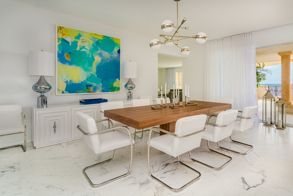 Photo of a large beach style separate dining room in New York with white walls, marble floors, no fireplace and white floor.