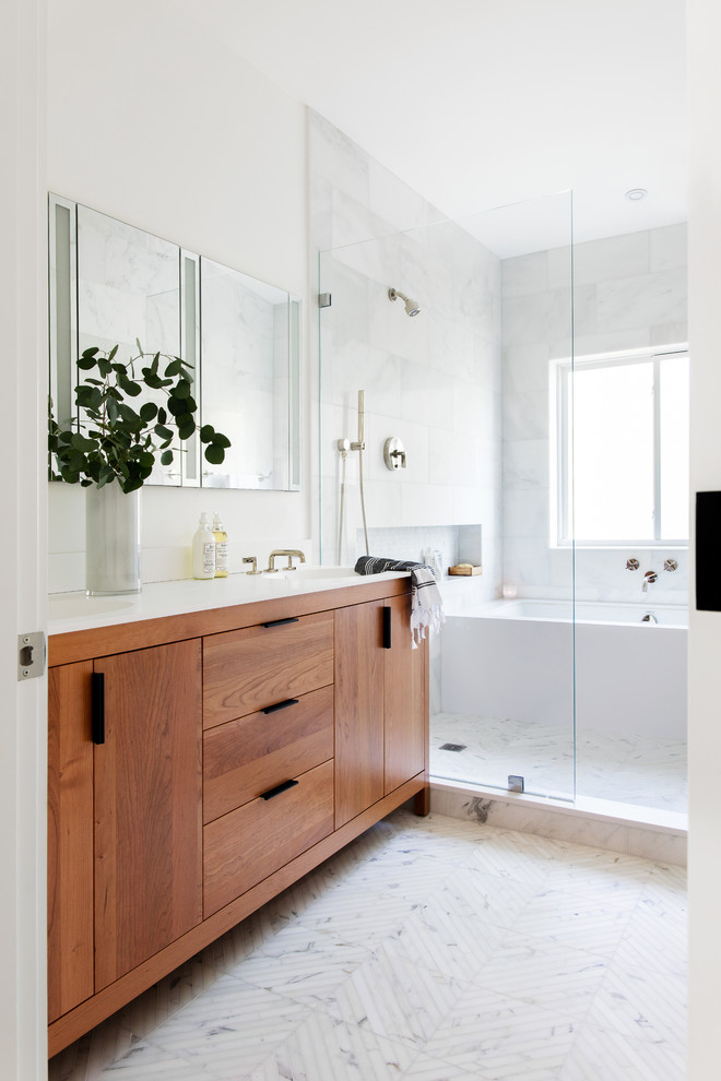 Mid-sized modern master bathroom in San Francisco with medium wood cabinets, an undermount tub, an open shower, a one-piece toilet, white tile, stone tile, white walls, marble floors, an integrated sink, engineered quartz benchtops, white floor, an open shower, white benchtops and flat-panel cabinets.