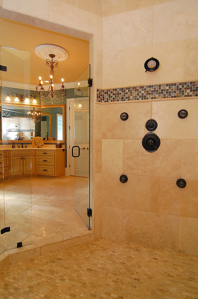 Design ideas for a large traditional master bathroom in Charleston with raised-panel cabinets, yellow cabinets, a drop-in tub, a corner shower, beige tile, blue walls, ceramic floors, an undermount sink, granite benchtops, beige floor and a hinged shower door.
