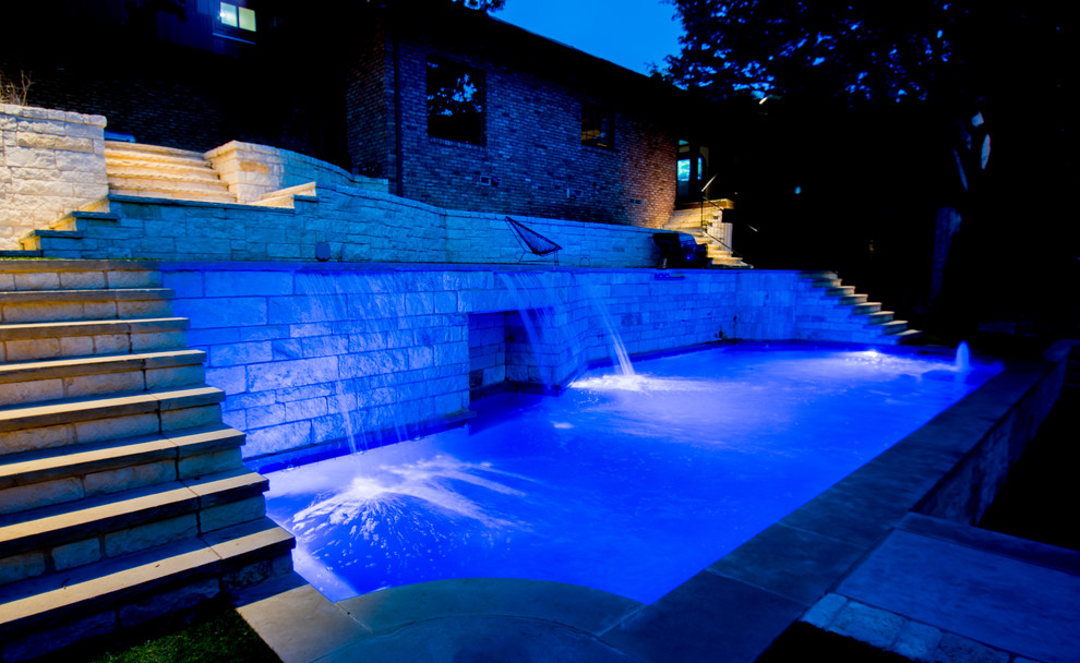 Photo of a mid-sized modern backyard custom-shaped pool in Dallas with natural stone pavers.