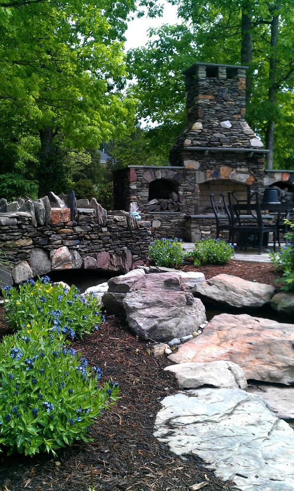 Design ideas for a large country backyard partial sun garden for summer in DC Metro with a water feature and natural stone pavers.