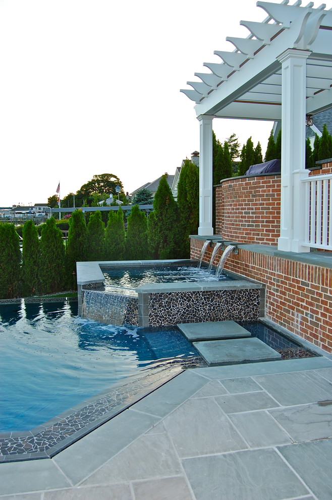 Inspiration for a beach style pool in New York with a hot tub.