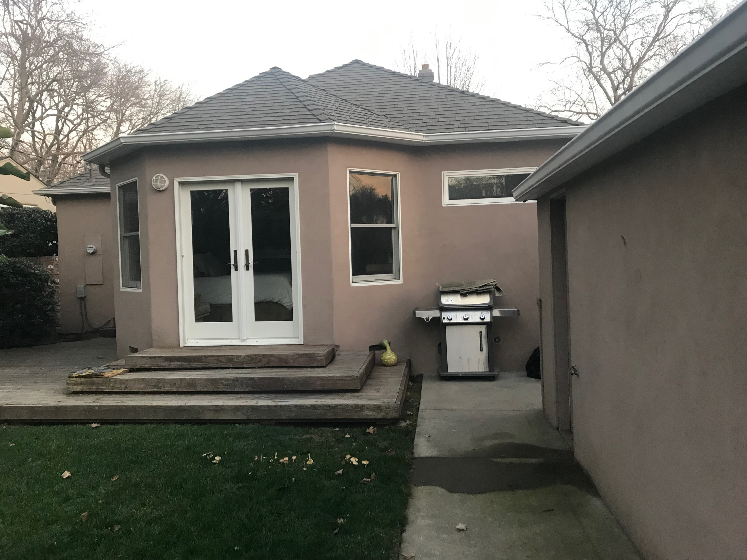 Before: Small, Unusable Patio with Aging Wood Steps and BBQ without a place