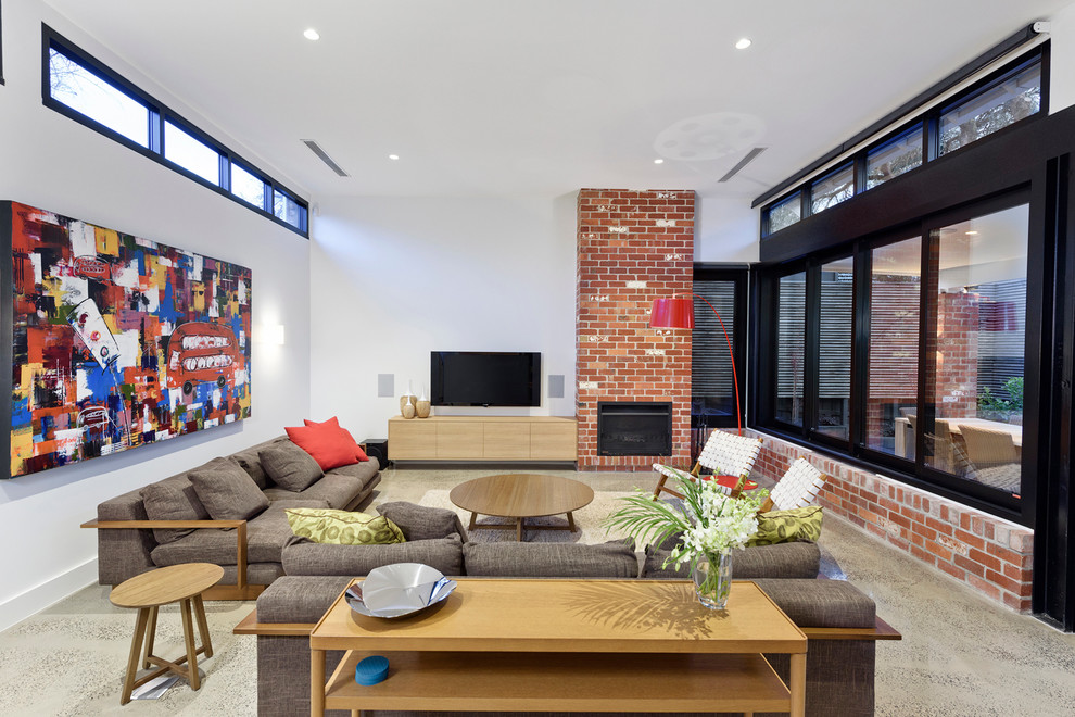 Design ideas for a contemporary family room in Melbourne with white walls, a standard fireplace and a wall-mounted tv.