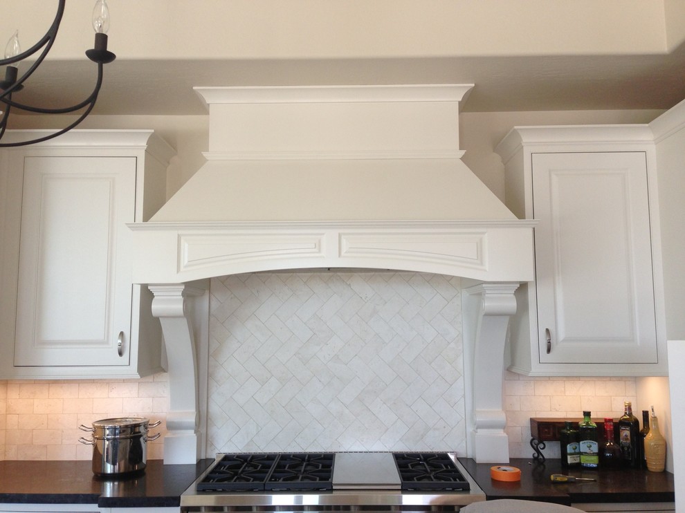 Kitchen - transitional dark wood floor kitchen idea in Phoenix with white cabinets, granite countertops, white backsplash, stainless steel appliances and an island