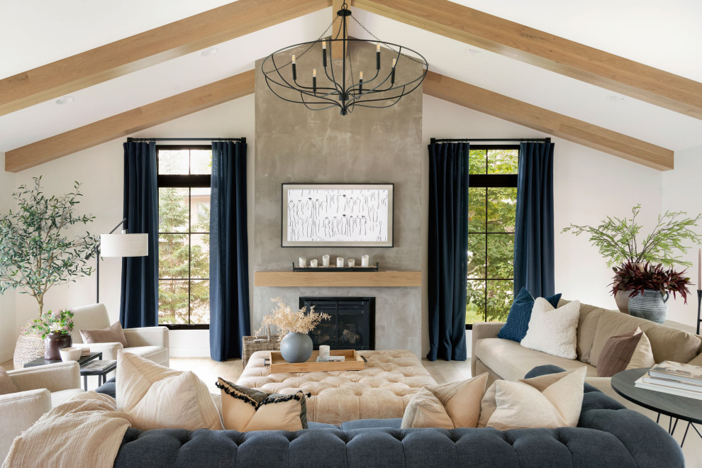 Nautical open plan living room in Minneapolis with white walls, light hardwood flooring, a standard fireplace, exposed beams and a vaulted ceiling.