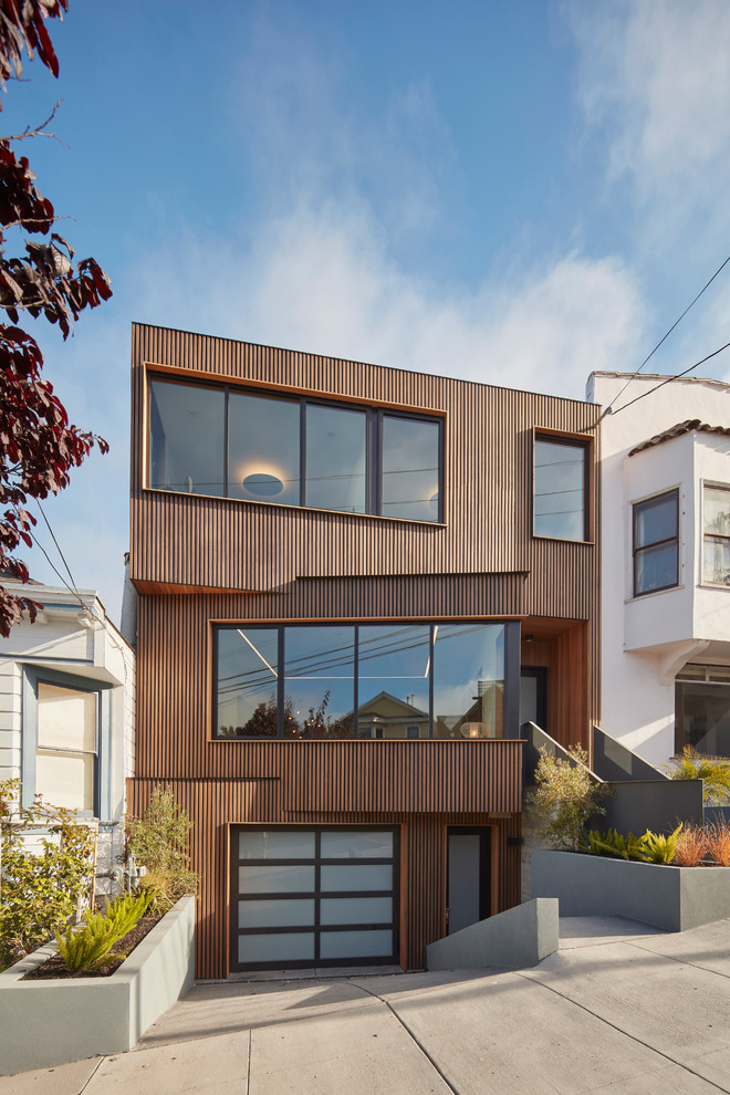 Inspiration for a mid-sized contemporary three-storey brown house exterior in San Francisco with wood siding and a flat roof.