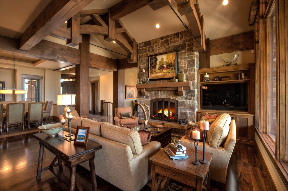 Inspiration for an expansive transitional open concept living room in Salt Lake City with beige walls, dark hardwood floors, a standard fireplace, a stone fireplace surround and a built-in media wall.