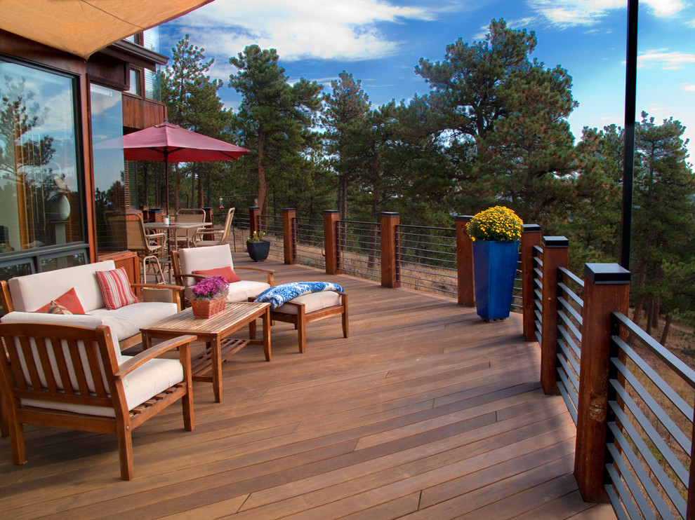 Example of a mid-sized mountain style backyard deck design in Denver with no cover