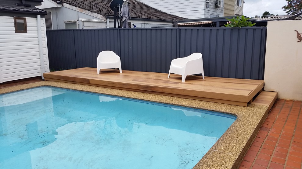 This is an example of a small modern backyard pool in Sydney with decking.