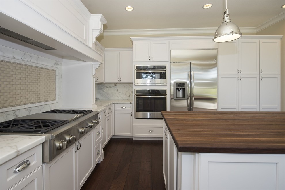 Inspiration for a large traditional l-shaped open plan kitchen in San Francisco with a drop-in sink, recessed-panel cabinets, white cabinets, marble benchtops, multi-coloured splashback, porcelain splashback, stainless steel appliances, medium hardwood floors, with island and multi-coloured floor.