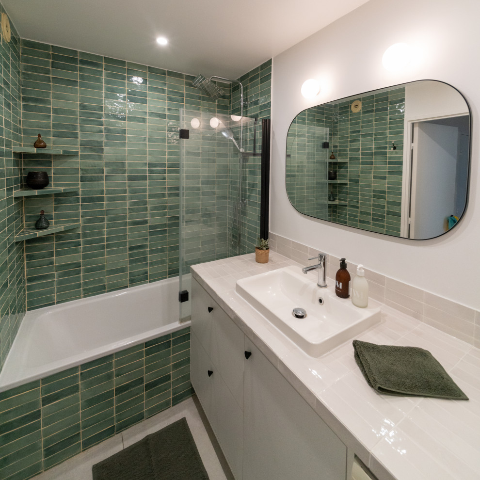 Photo of a mid-sized contemporary master bathroom in Paris with flat-panel cabinets, white cabinets, an undermount tub, green tile, ceramic tile, white walls, ceramic floors, a drop-in sink, tile benchtops, white floor, white benchtops, a single vanity and a freestanding vanity.