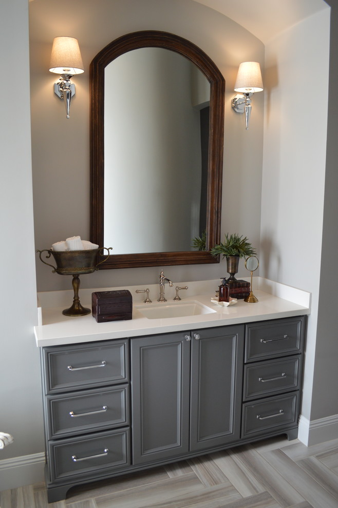 Inspiration for a transitional master gray tile and porcelain tile porcelain tile freestanding bathtub remodel in Phoenix with recessed-panel cabinets, gray cabinets, gray walls, an undermount sink and solid surface countertops