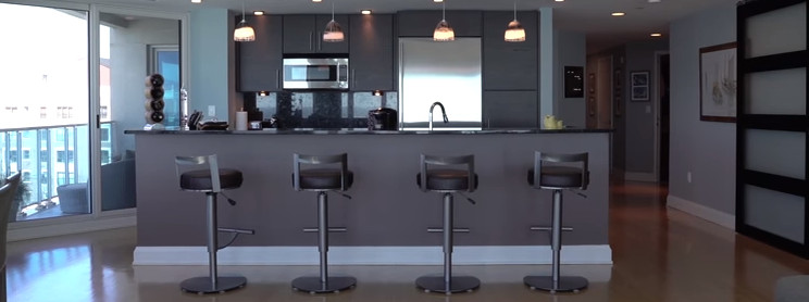 Example of a transitional u-shaped eat-in kitchen design with flat-panel cabinets, brown cabinets and a peninsula