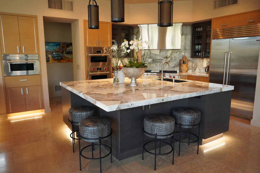 This is an example of a large contemporary u-shaped eat-in kitchen in Phoenix with a single-bowl sink, flat-panel cabinets, dark wood cabinets, quartzite benchtops, multi-coloured splashback, stone slab splashback, stainless steel appliances, limestone floors, multiple islands, beige floor and multi-coloured benchtop.