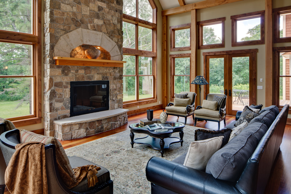 Inspiration for a traditional living room in Minneapolis with a standard fireplace and a stone fireplace surround.