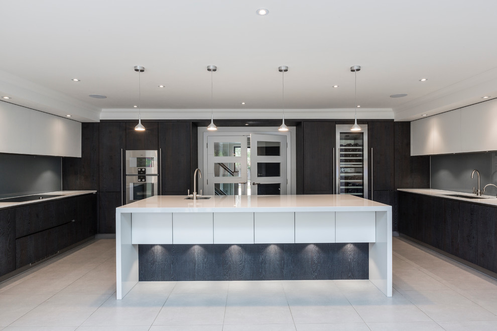 Large contemporary u-shaped open plan kitchen in Surrey with with island.