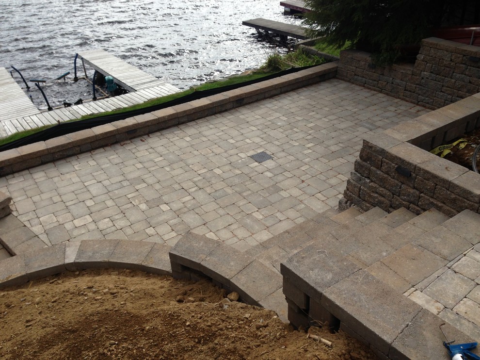 Inspiration for a mid-sized traditional backyard patio in Boston with natural stone pavers and no cover.