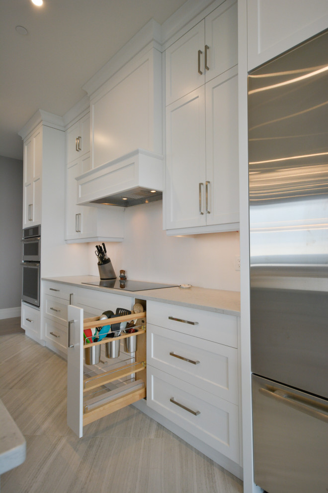 Mid-sized transitional open concept kitchen photo in Toronto with shaker cabinets, white cabinets, quartz countertops, stainless steel appliances, a peninsula and white countertops
