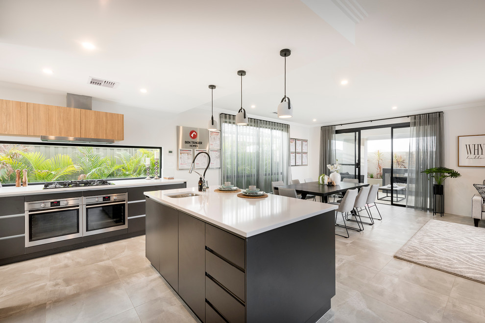 This is an example of a mid-sized modern galley open plan kitchen in Perth with a drop-in sink, flat-panel cabinets, black cabinets, quartz benchtops, stainless steel appliances, porcelain floors and with island.
