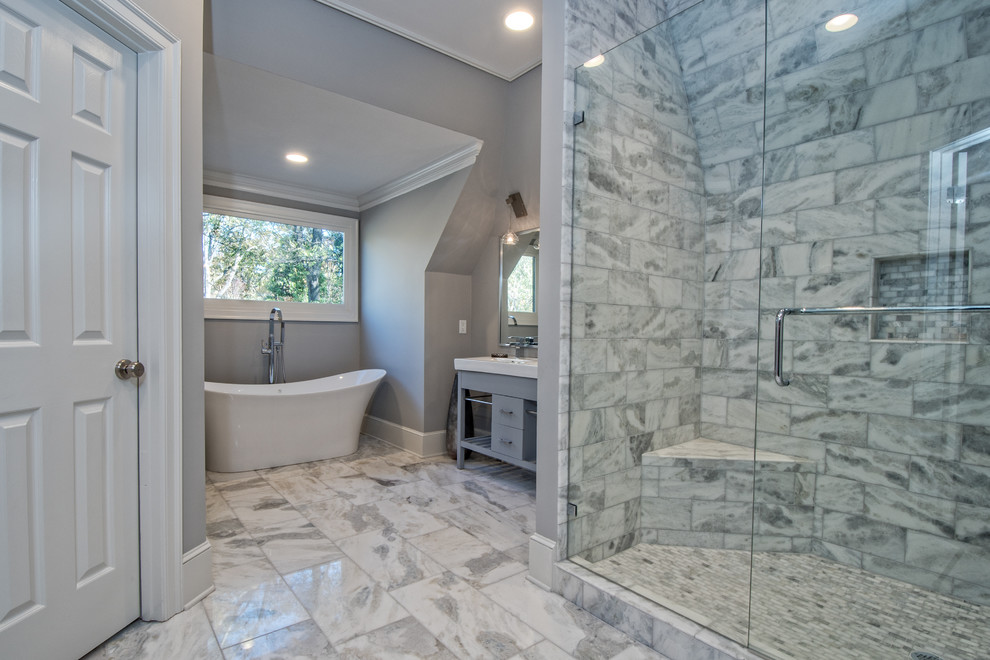 Photo of a small contemporary 3/4 bathroom in Other with furniture-like cabinets, grey cabinets, a freestanding tub, an open shower, gray tile, mosaic tile, grey walls, marble floors, an integrated sink and solid surface benchtops.