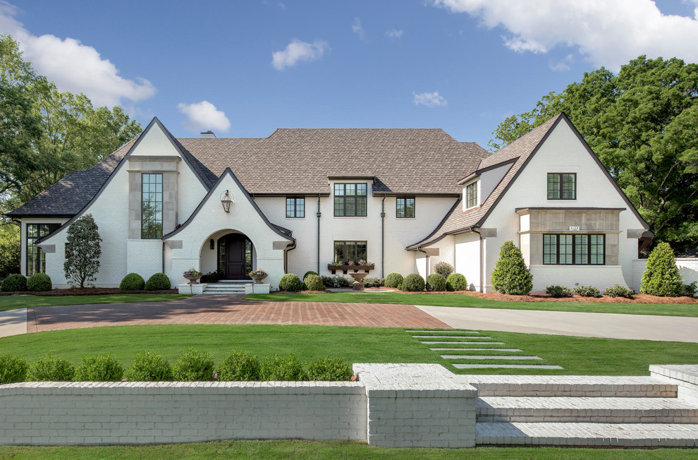 Inspiration for a large traditional three-storey brick white house exterior in Charlotte with a shingle roof.